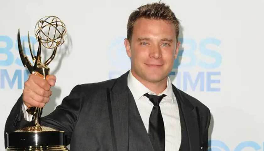 Billy Miller holds up one of his three Daytime Emmys