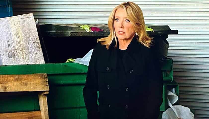 Y&R Scoop: Nikki Newman stands beside a dumpster