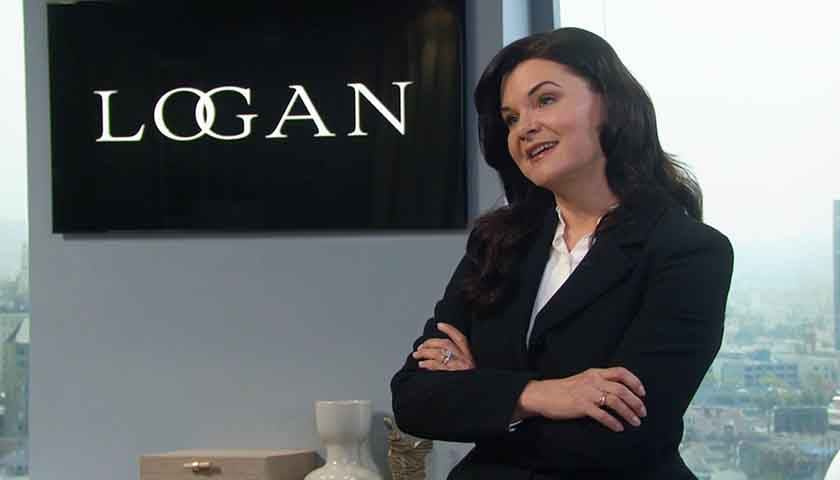 B&B Scoop: Katie stands in front of her Logan fashion house sign