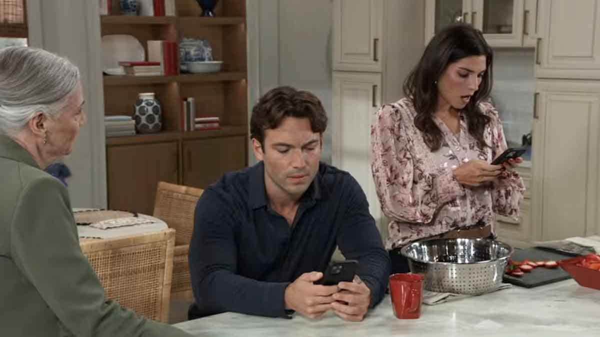 Brook Lynn's mouth hangs open as Michael and Tracy look at their phones on General Hospital