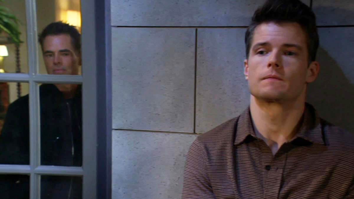 Billy looks out the balcony window as Kyle hides on Young And The Restless