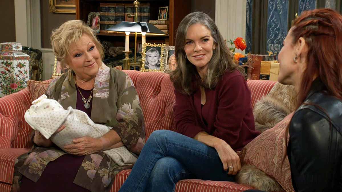 Traci holds Ruby as Diane smiles at Sally